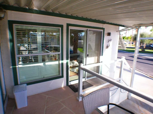 a view of a two chairs in the balcony
