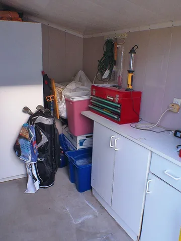 a view of a swimming pool with a yard and large trees