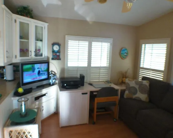 a room with furniture a flat screen tv and a window