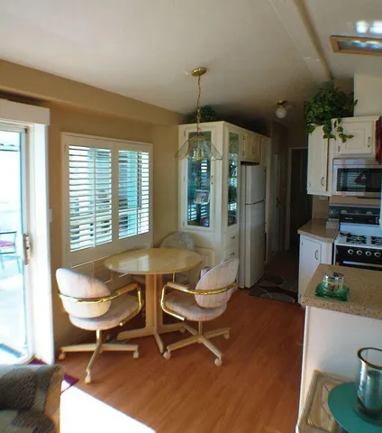 a living room with furniture a flat screen tv and a dining table
