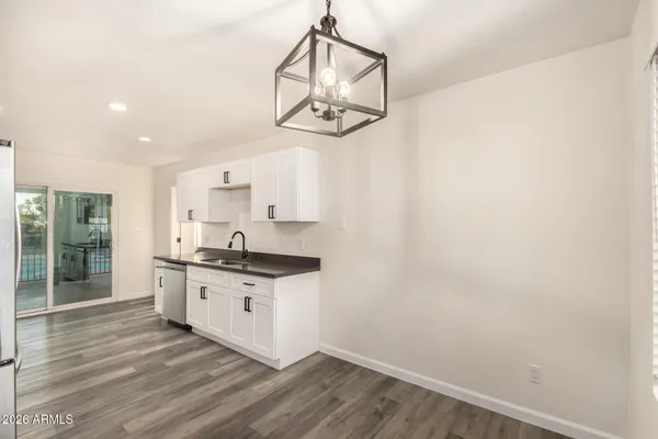 a kitchen with a sink cabinets and wooden floor