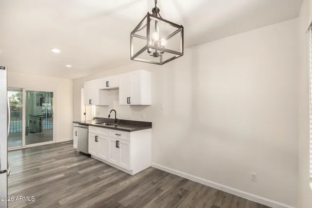 a kitchen with a sink cabinets and wooden floor