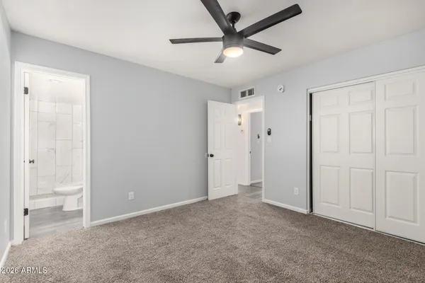 a view of an empty room and a bathroom