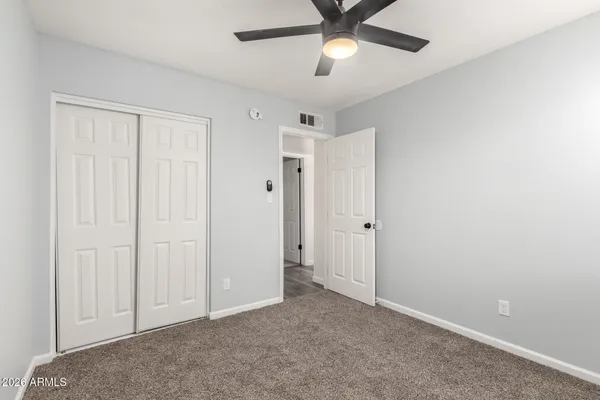 an empty room with closet area