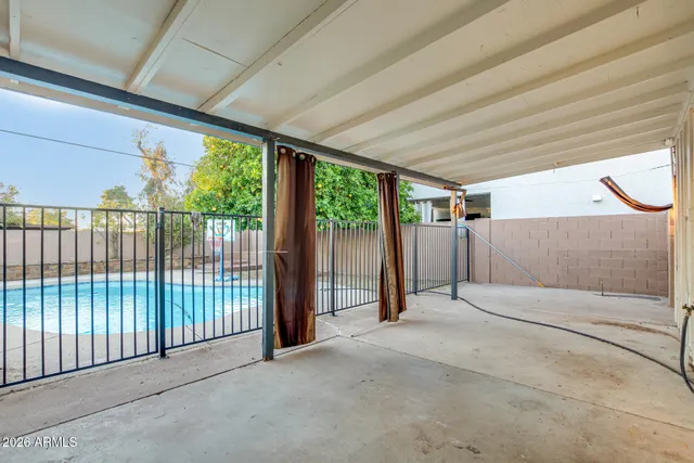 a view of a house with swimming pool and sitting area