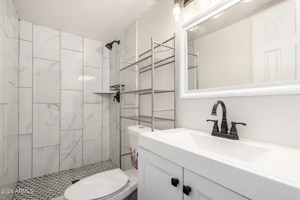 a bathroom with a sink toilet and shower