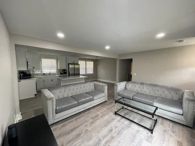 a living room with furniture and wooden floor