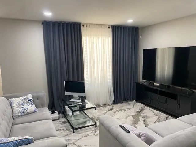 a view of a dining room with furniture and window