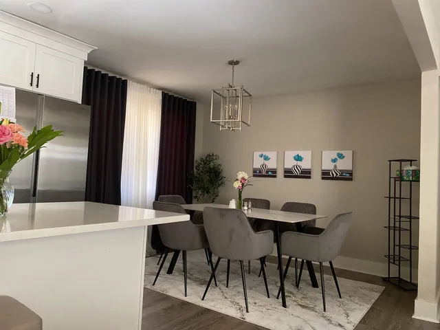 a large bed sitting in a room next to a cabinet