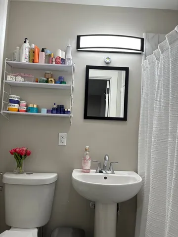 a bedroom with a bed and a mirror