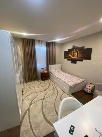 a bedroom with furniture and a wooden floor