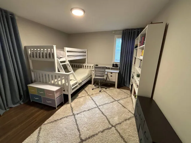 a view of a livingroom with furniture staircase and a wooden floor