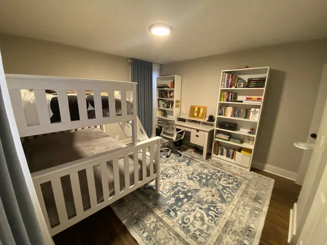 a bedroom with furniture and a book shelf