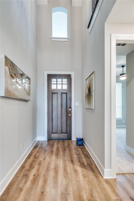 1309 Old Rocksprings Pass Mansfield, TX 76063 - Photo 3 of 36 Two-story foyer featuring a wood-finish entry door with clear glass panels, a high arched window, and wood-finish flooring