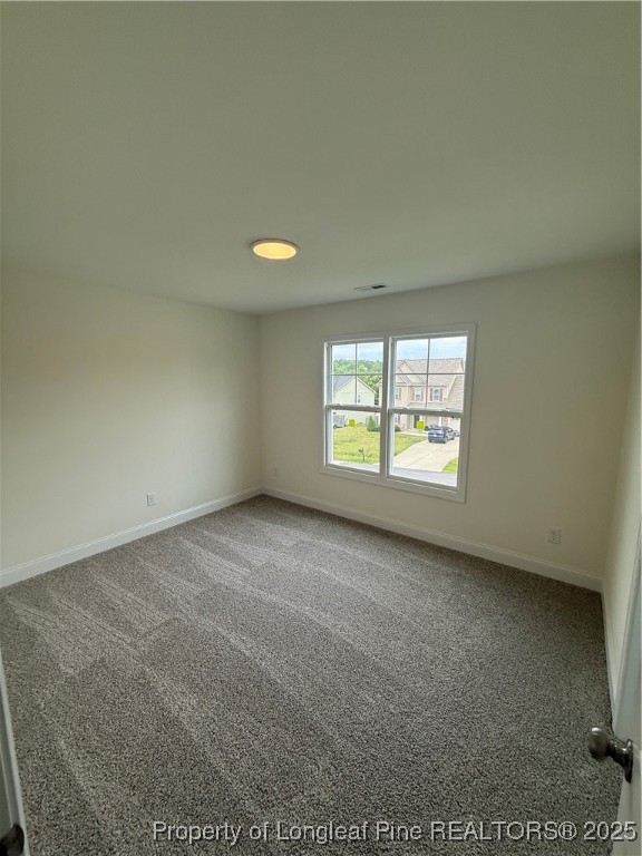 81 Reece Drive Sanford, NC 27332 - Photo 13 of 18 an empty room with windows