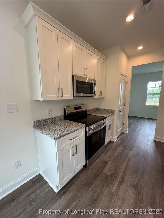 81 Reece Drive Sanford, NC 27332 - Photo 5 of 18 a kitchen with stainless steel appliances granite countertop a stove a sink and a microwave