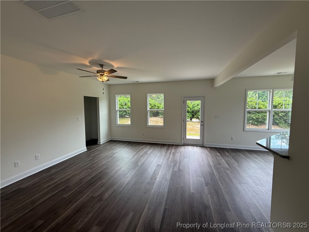 81 Reece Drive Sanford, NC 27332 - Photo 7 of 18 an empty room with wooden floor and windows