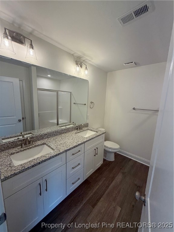 81 Reece Drive Sanford, NC 27332 - Photo 10 of 18 a bathroom with a granite countertop sink a large mirror a toilet and a vanity