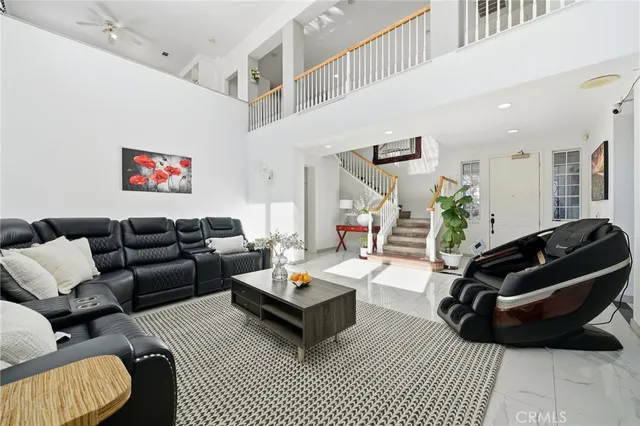 a living room with furniture rug and a window