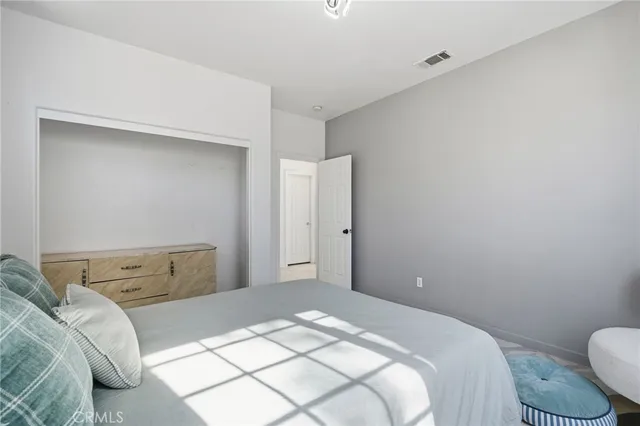 a bedroom with a bed and a dresser