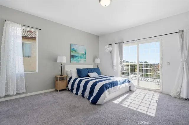a bedroom with bed and a painting on the wall