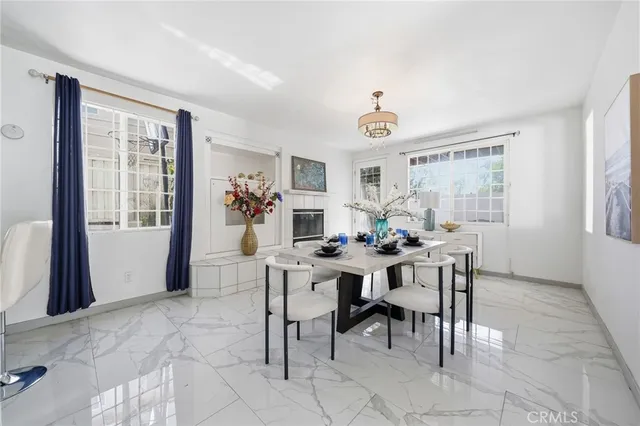 a view of a a dining room with furniture window and wooden floor