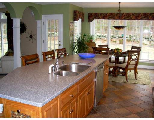 15 Deer Ridge Road Ashland, MA 01721 - Photo 9 of 24 a kitchen with stainless steel appliances granite countertop a sink counter and chairs