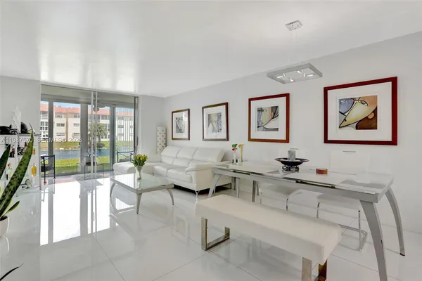 a living room with furniture a large window and a flat screen tv