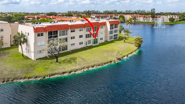 an aerial view of residential houses with outdoor space and seating