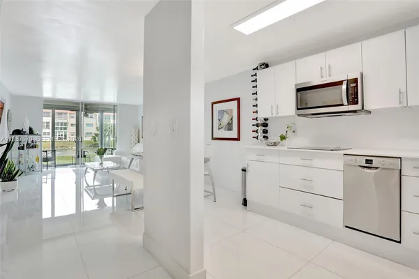 a room with white cabinets and flat screen tv