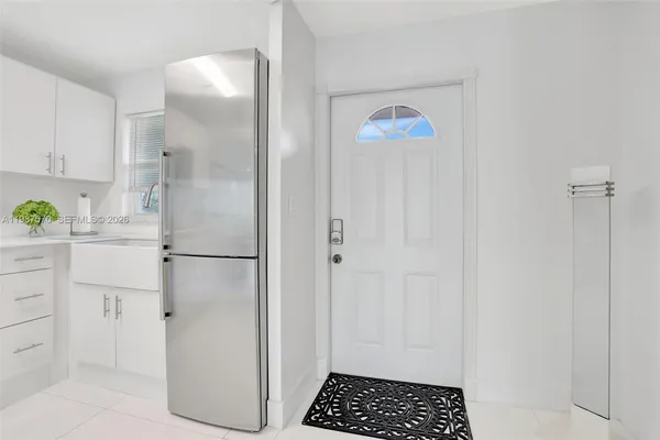 a white refrigerator freezer and a stove sitting inside of a kitchen