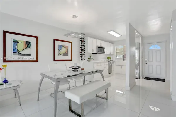 a living room with furniture and kitchen view