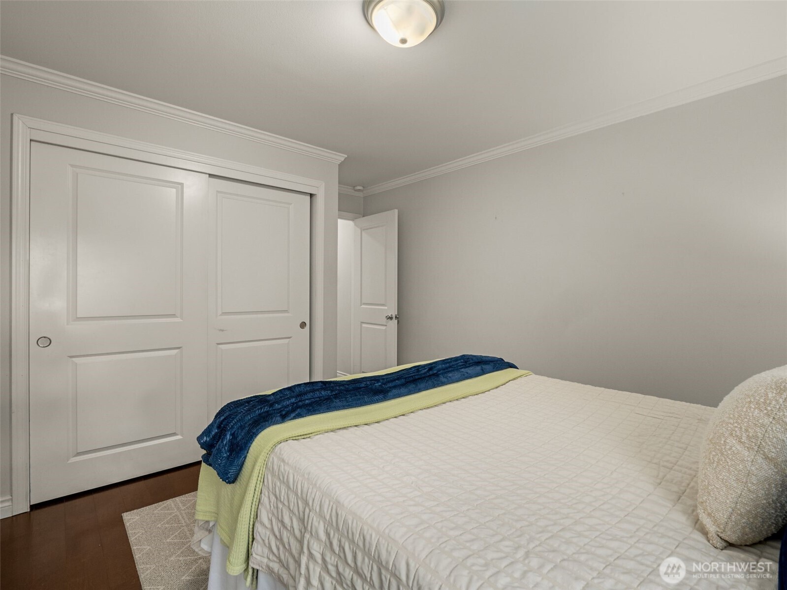 3928 South Pilgrim Street Seattle, WA 98118 - Photo 14 of 27 a bedroom with a bed and a wooden floor