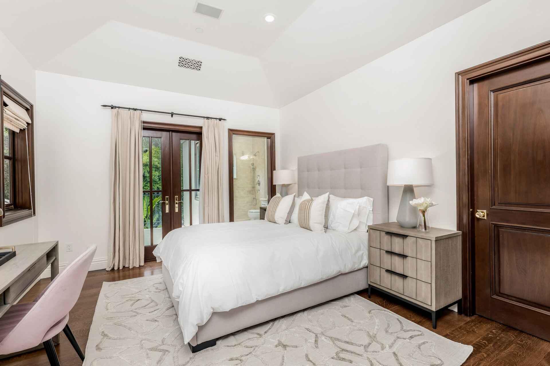 2084 East Valley Road, Unit SHARE 1 Santa Barbara, CA 93108 - Photo 20 of 35 a bedroom with a large bed and a chandelier