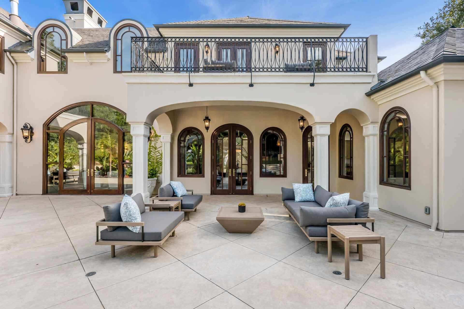 2084 East Valley Road, Unit SHARE 1 Santa Barbara, CA 93108 - Photo 28 of 35 a living room with couches a fireplace and a dining table with garden view