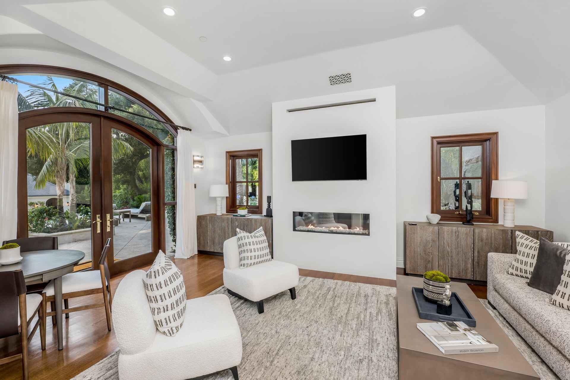 2084 East Valley Road, Unit SHARE 1 Santa Barbara, CA 93108 - Photo 31 of 35 a living room with furniture a flat screen tv and a floor to ceiling window