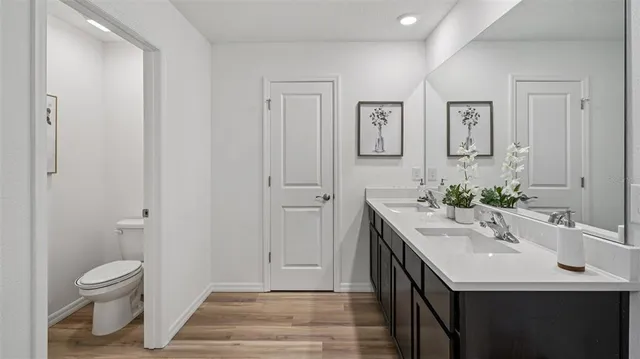a bathroom with a shower sink and mirror