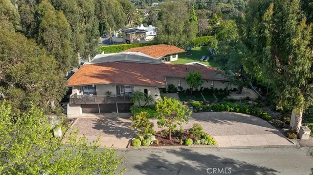 an aerial view of a house with yard patio and outdoor seating