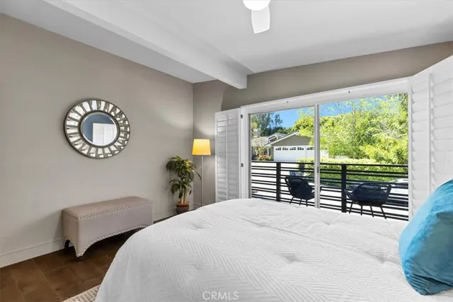 a spacious bedroom with a bed and wooden floor