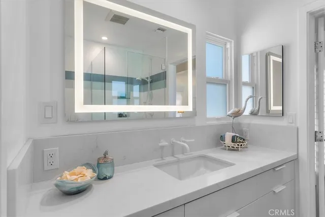 a dining room with furniture a large window and a chandelier