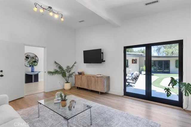 a view of a house with backyard porch and sitting area