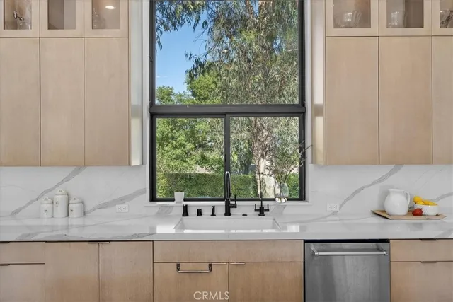 a large white kitchen with a large window and refrigerator