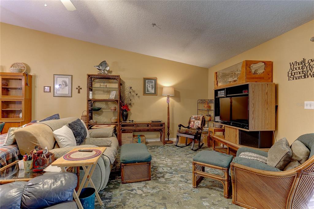 8405 Terrace Meadows Court, Unit 8405 Temple Terrace, FL 33637 - Photo 11 of 28 a living room with furniture and a flat screen tv