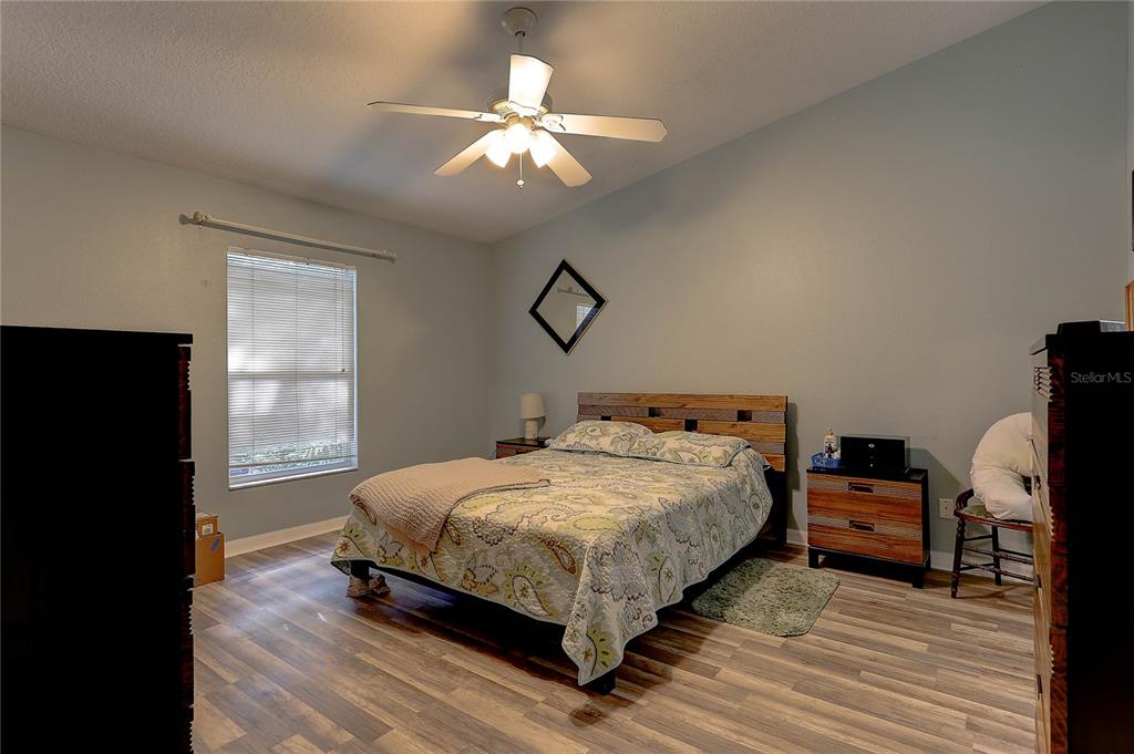 8405 Terrace Meadows Court, Unit 8405 Temple Terrace, FL 33637 - Photo 16 of 28 a bedroom with a bed and wooden floor