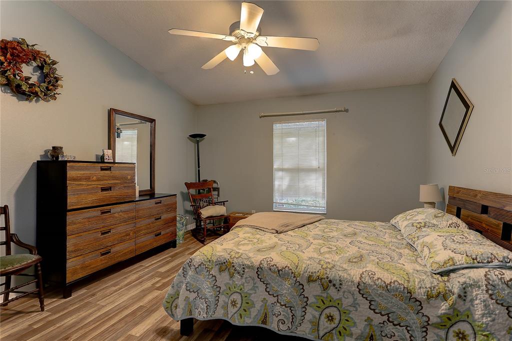 8405 Terrace Meadows Court, Unit 8405 Temple Terrace, FL 33637 - Photo 17 of 28 a bedroom with a bed and a chandelier