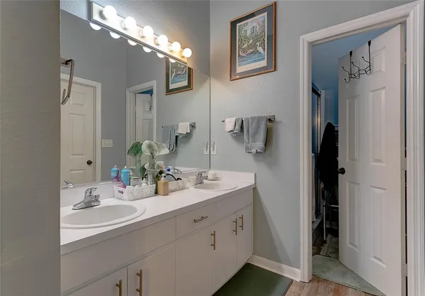 a bathroom with a sink double vanity and a mirror