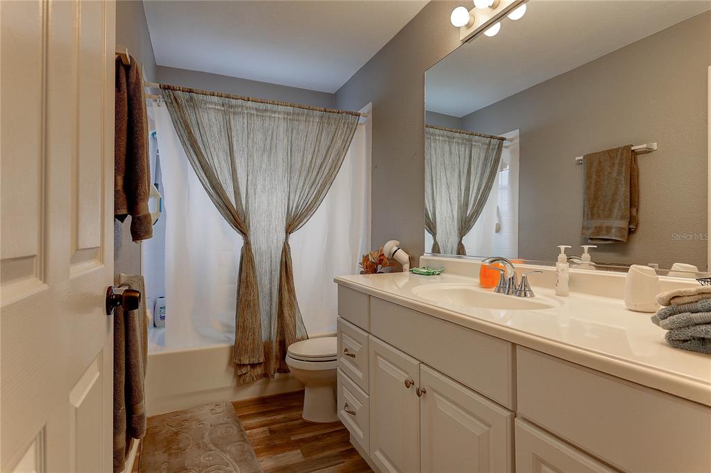 8405 Terrace Meadows Court, Unit 8405 Temple Terrace, FL 33637 - Photo 21 of 28 a bathroom with a sink a toilet and a mirror