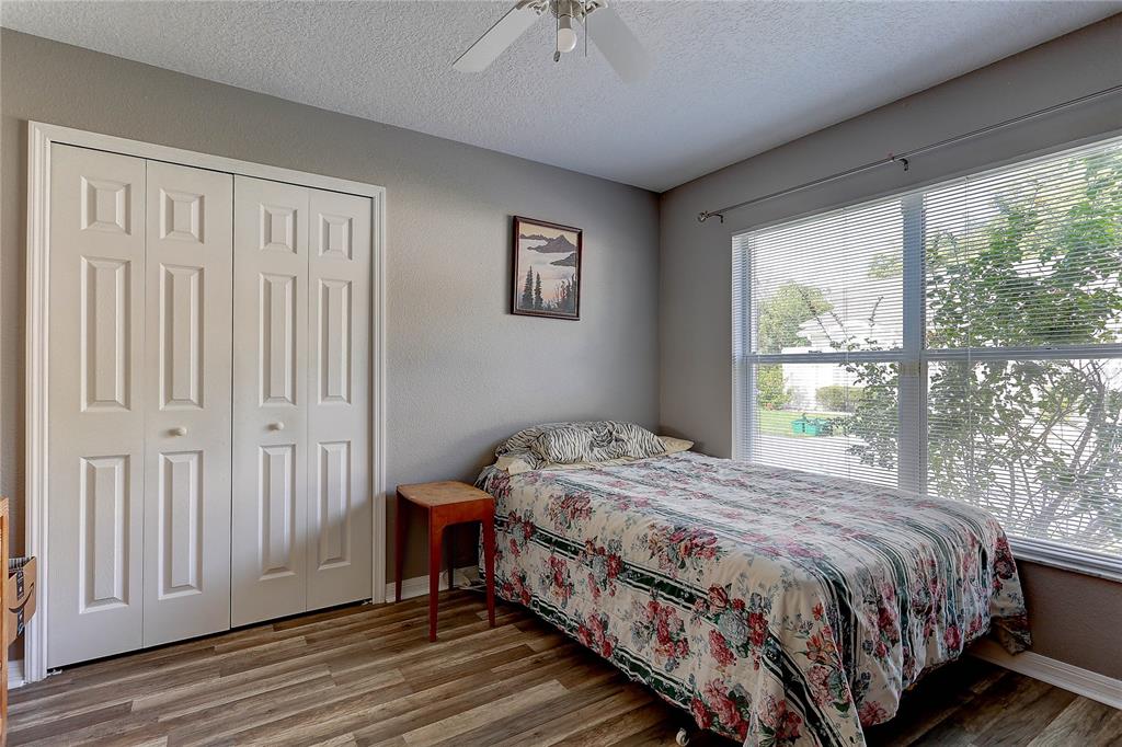 8405 Terrace Meadows Court, Unit 8405 Temple Terrace, FL 33637 - Photo 22 of 28 a bedroom with a bed a window and a balcony