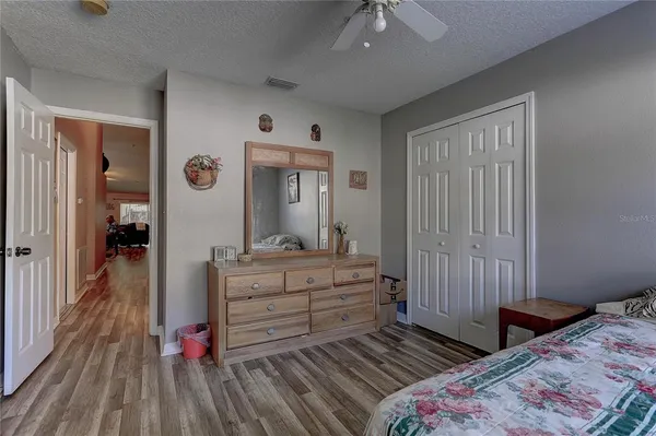 a bedroom with a bed and a dresser