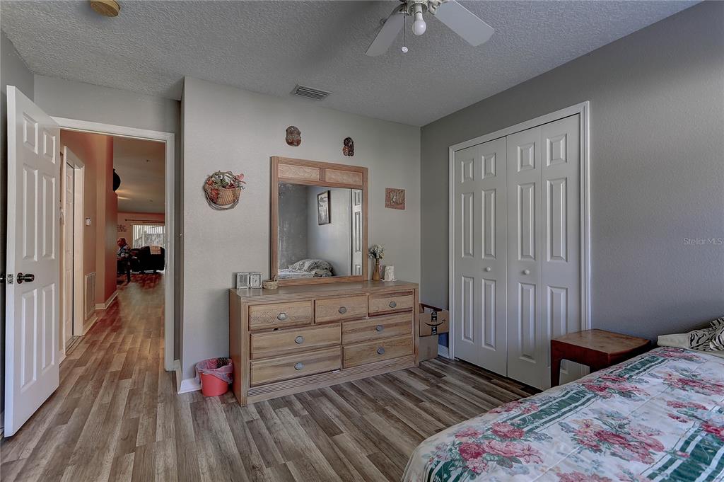 8405 Terrace Meadows Court, Unit 8405 Temple Terrace, FL 33637 - Photo 23 of 28 a bedroom with a bed and a dresser